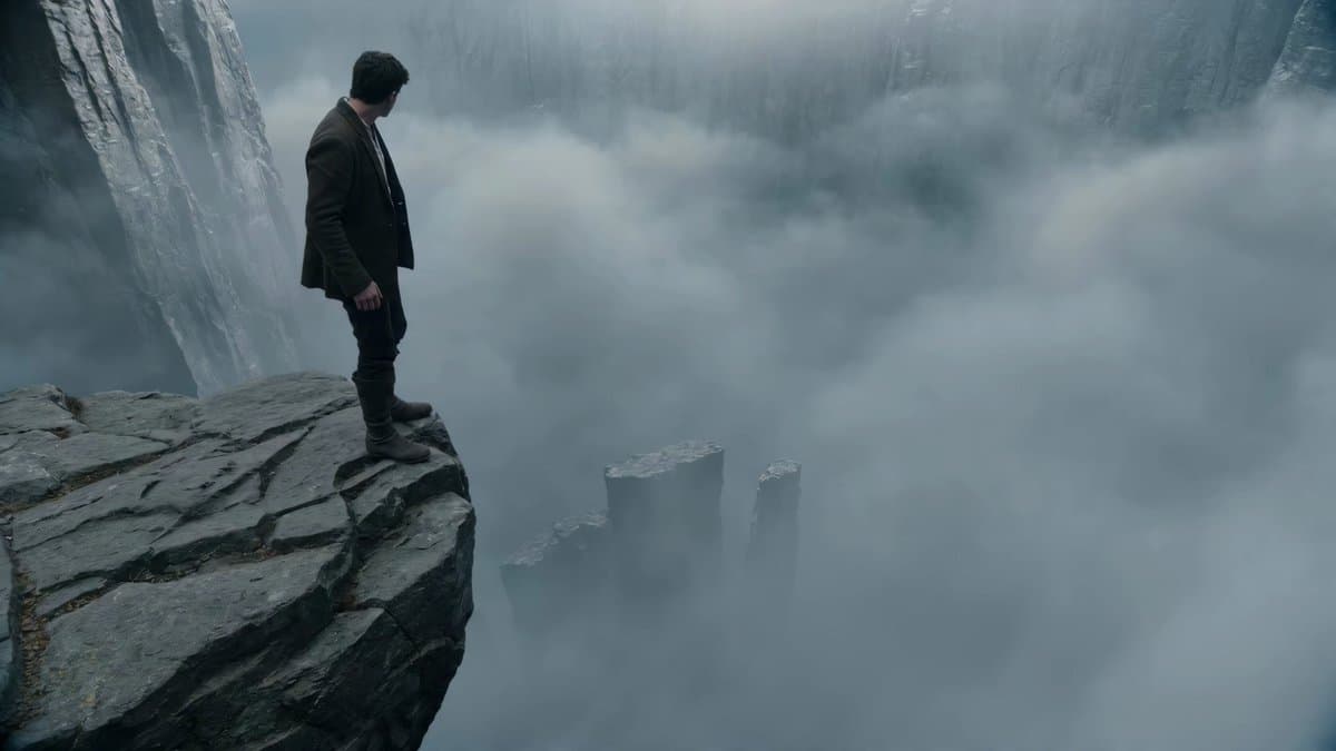 An adventurer descends from one towering cliff edge to another far below,...