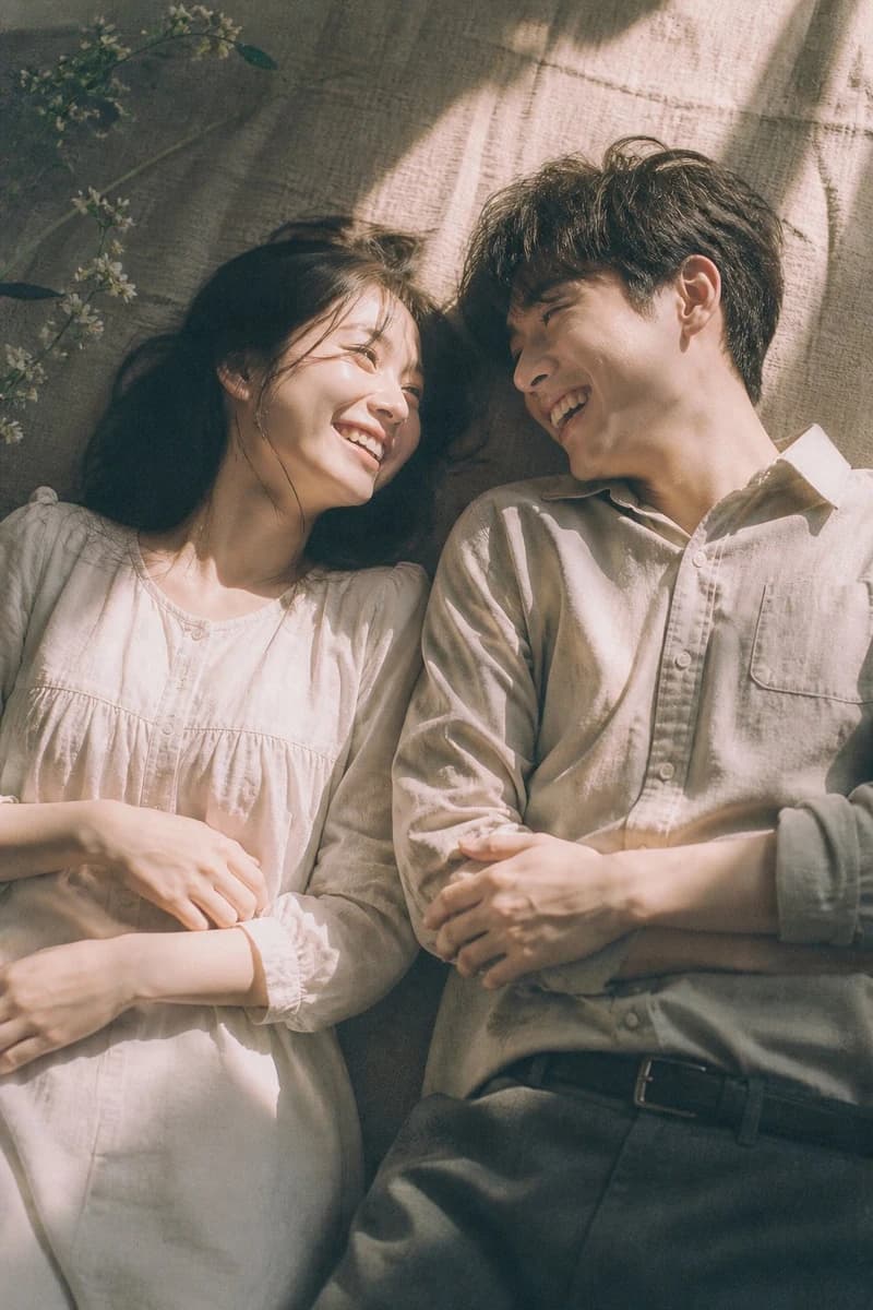A cinematic top-down portrait in aesthetic style of a young couple lying...