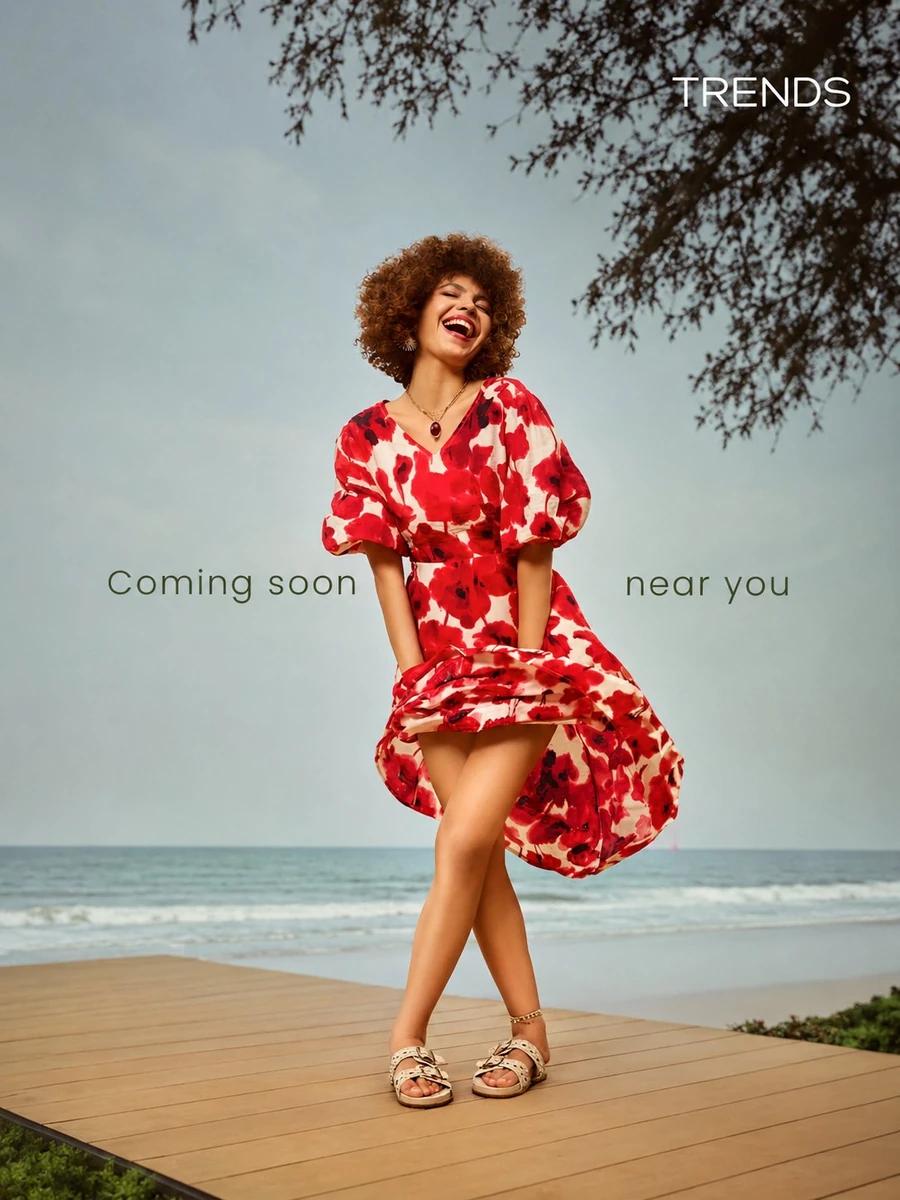 A joyful young woman with beautiful voluminous curly afro brown hair, lau...
