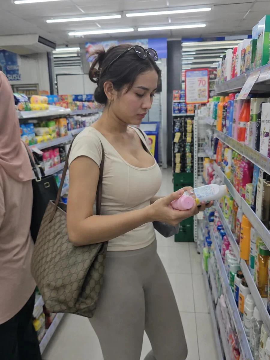 Photorealistic candid lifestyle photo of a young woman shopping in a brig...