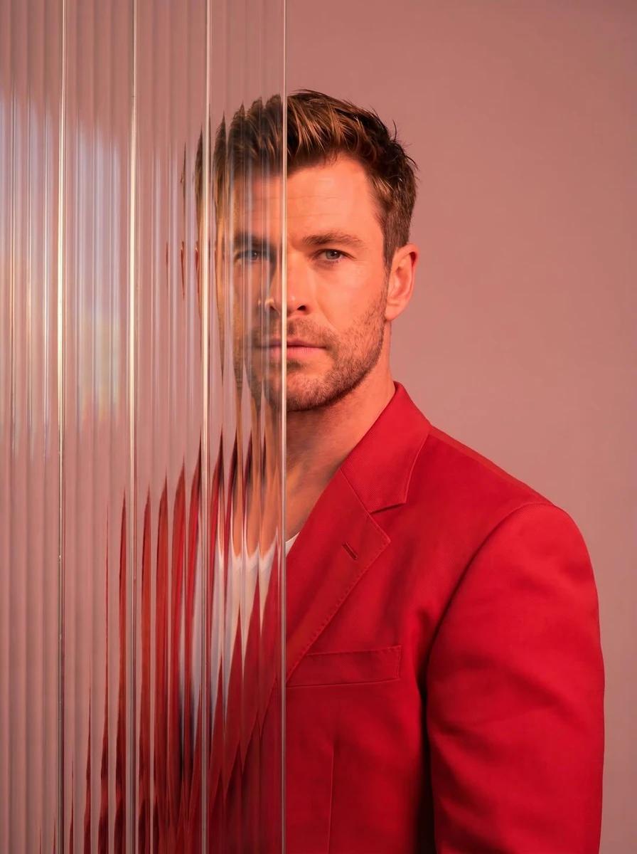 A striking editorial portrait photograph of a person wearing a red blazer...