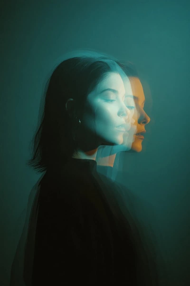 Cinematic double exposure portrait of a woman in side profile, two overla...