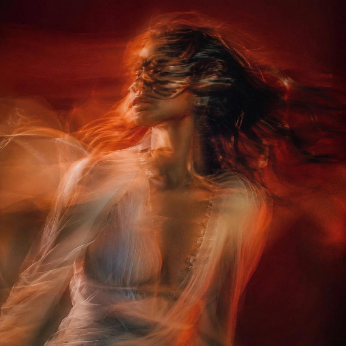 Cinematic motion blurred portrait of a woman in fluid motion, face partia...