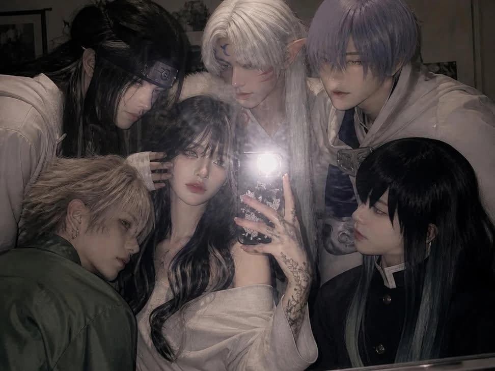 Holding a phone with the flash on, taking a mirror selfie in a slightly m...