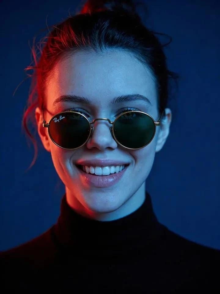 Ultra-realistic cinematic portrait of a young woman wearing round vintage...